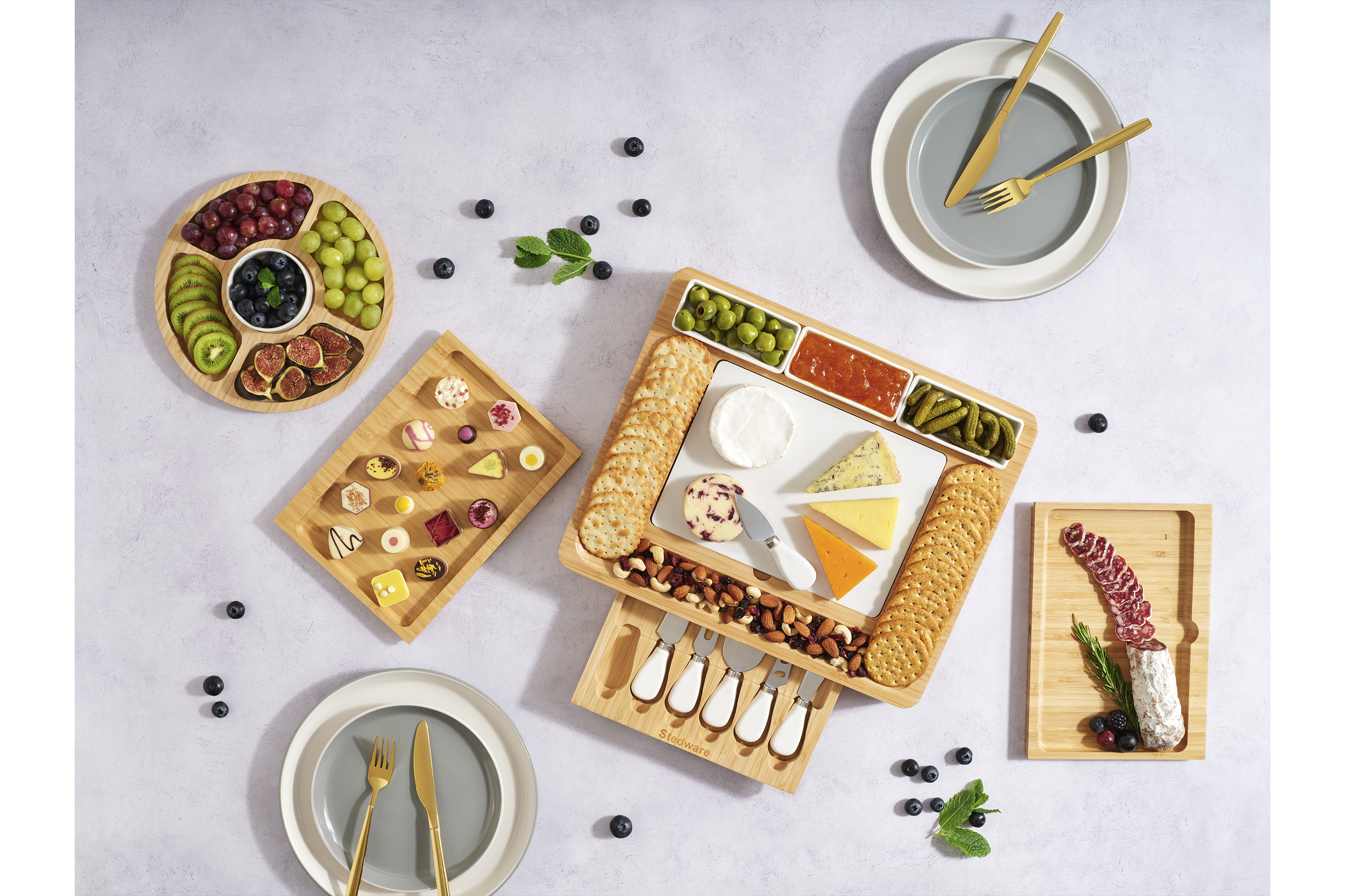Food flat lay photo shoot cheeseboards with cheeses and meats summer lighting on a Marble floor